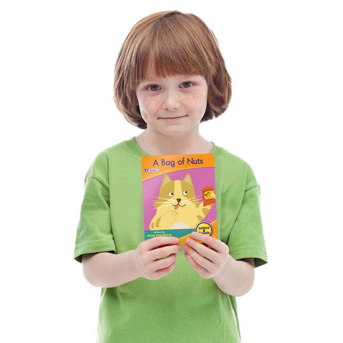 Child holding a Junior Learning JL381 Letters and Sounds Phase 2 Set 1 Fiction book