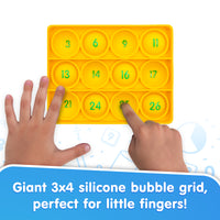 Giant 3x4 silicone bubble grid with numbers, showing hands interacting with it.